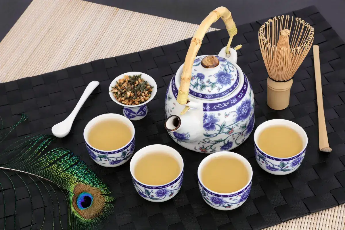 A traditional tea ceremony set with a small teapot and cups.